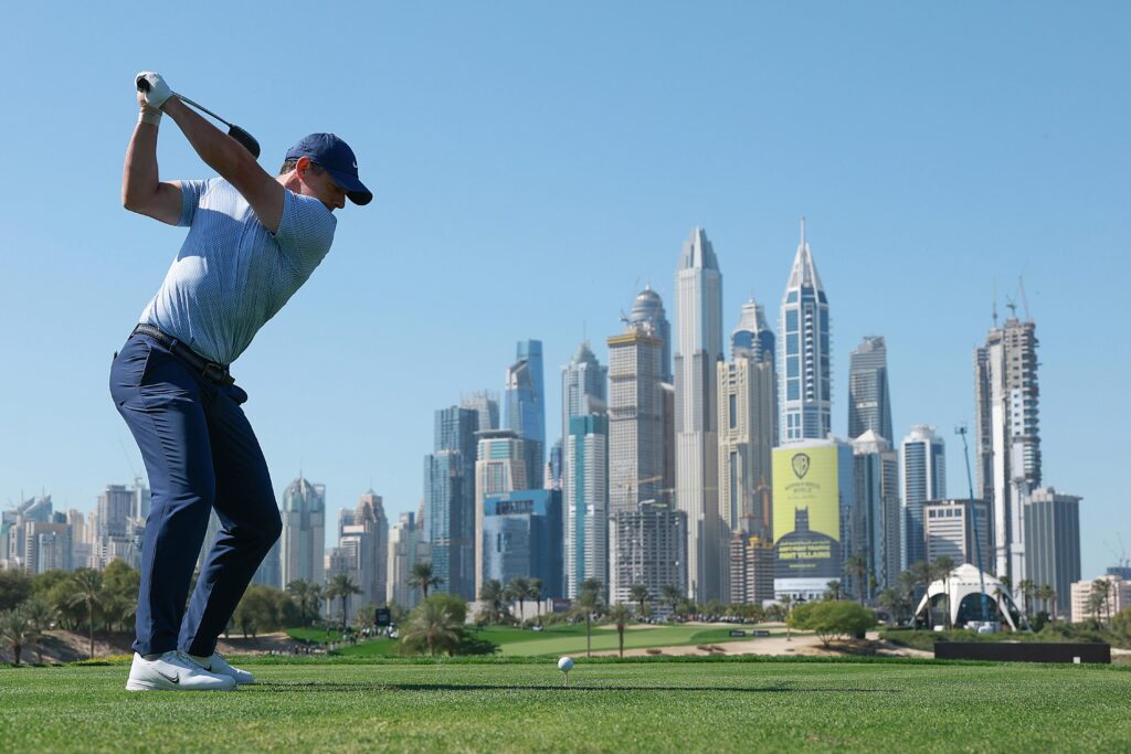 Rory McIlroy tees off with Dubai skyline in the background during the 2026 Hero Dubai Desert Classic